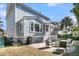 Beautiful home exterior with a screened porch, a well-maintained lawn, and a cozy patio area at 4108 Whiting St, Mount Pleasant, SC 29466