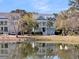 Exterior view of a two-story light blue house with a pond reflecting its image in the foreground at 4108 Whiting St, Mount Pleasant, SC 29466
