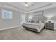 Serene main bedroom with soft gray walls, plush carpet, a tufted headboard, and a door leading to the outside at 4108 Whiting St, Mount Pleasant, SC 29466