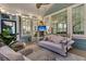 Relaxing screened-in porch with comfortable seating, a swing, and a mounted TV for outdoor entertainment at 4108 Whiting St, Mount Pleasant, SC 29466