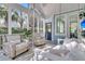 Inviting screened-in porch with comfortable seating, including a swing, and natural light with serene outdoor views at 4108 Whiting St, Mount Pleasant, SC 29466