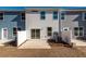 A view of the backyard featuring a concrete patio and vinyl fencing for privacy, with sliding glass doors for indoor/outdoor living at 418 Duskywing Dr, Goose Creek, SC 29445
