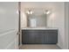 Modern bathroom featuring a double vanity with granite countertops and gray cabinetry at 418 Duskywing Dr, Goose Creek, SC 29445