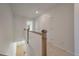 Upstairs hallway with wooden railings and a view of the first floor showcases the home's bright and airy design at 418 Duskywing Dr, Goose Creek, SC 29445