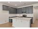 Modern kitchen with gray cabinets, stainless steel appliances, and a central island with seating at 418 Duskywing Dr, Goose Creek, SC 29445