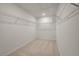 Bright walk-in closet with installed shelving and carpeted floor at 418 Duskywing Dr, Goose Creek, SC 29445