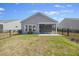 View of the backyard featuring a screened in porch, trimmed lawn, and black aluminum fencing at 422 Switchgrass Dr, Summerville, SC 29486