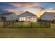 Backyard view showcasing a screened in porch, fenced yard, and outdoor living at 422 Switchgrass Dr, Summerville, SC 29486