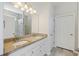 Bright bathroom features a double sink vanity with granite countertops, a large mirror, and plenty of storage at 422 Switchgrass Dr, Summerville, SC 29486