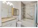 Bathroom features a granite countertop, and shower over tub with tiled walls and handrails at 422 Switchgrass Dr, Summerville, SC 29486