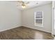 Bright bedroom featuring wood-look flooring, a window with blinds, and a ceiling fan with light fixture at 422 Switchgrass Dr, Summerville, SC 29486