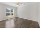 This empty bedroom features hardwood floors, a window for natural light, and ample space for personalization at 422 Switchgrass Dr, Summerville, SC 29486