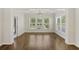 Bright dining room features wood floors, natural light from the large windows, and a modern chandelier at 422 Switchgrass Dr, Summerville, SC 29486