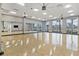 Large fitness center with floor to ceiling windows, light hardwood floors, and ceiling fans at 422 Switchgrass Dr, Summerville, SC 29486