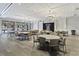 Large game room with neutral tones, light wood floors, and tables and chairs under elegant lighting fixtures at 422 Switchgrass Dr, Summerville, SC 29486