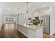 Bright kitchen features stainless appliances, large island with seating, and open to the living space at 422 Switchgrass Dr, Summerville, SC 29486