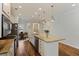 Bright kitchen features a large island with stone countertops, stainless steel appliances, and wooden floors at 422 Switchgrass Dr, Summerville, SC 29486