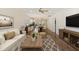 Open-concept living room boasts modern furnishings, hardwood floors, and seamlessly connects to the kitchen and dining area at 422 Switchgrass Dr, Summerville, SC 29486