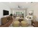 Comfortable living room with neutral tones, a ceiling fan, and a view into an adjacent sunroom at 422 Switchgrass Dr, Summerville, SC 29486
