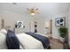 The main bedroom features a ceiling fan, a large bed, and a view of the ensuite bathroom at 422 Switchgrass Dr, Summerville, SC 29486