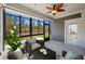Cozy sunroom features screened-in windows, ceiling fan, backyard views, and comfortable seating at 422 Switchgrass Dr, Summerville, SC 29486