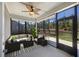 Cozy screened porch with comfortable seating, ceiling fan, and scenic backyard views for relaxed enjoyment at 422 Switchgrass Dr, Summerville, SC 29486