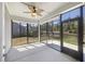 Sunroom featuring screened windows and a ceiling fan with a door to the backyard at 422 Switchgrass Dr, Summerville, SC 29486