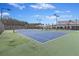 Scenic tennis courts surrounded by trees, providing an excellent place for recreational activities at 422 Switchgrass Dr, Summerville, SC 29486