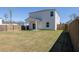 Spacious backyard with a covered patio, grassy lawn, and wooden privacy fence at 455 Minim St, Charleston, SC 29414
