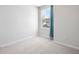 Bright bedroom with neutral carpet and walls, featuring a window with neighborhood view at 455 Minim St, Charleston, SC 29414