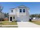 Charming two-story home with attached garage, driveway and landscaped front yard at 455 Minim St, Charleston, SC 29414
