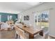 Open-concept living and dining area boasts hardwood floors, modern decor, and backyard access at 455 Minim St, Charleston, SC 29414