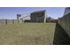 Large grassy backyard with a wooden fence surrounding the property and a house in the background at 491 Fox Sparrow Ct, Summerville, SC 29486