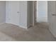 Neutral-toned bedroom showcasing plush carpeting and a view into an adjacent room at 491 Fox Sparrow Ct, Summerville, SC 29486