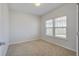 A bright bedroom with neutral carpeting and two windows allowing ample sunlight at 491 Fox Sparrow Ct, Summerville, SC 29486