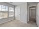 Cozy bedroom features two large windows, plush carpet, and a doorway at 491 Fox Sparrow Ct, Summerville, SC 29486
