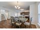 Bright dining area with wooden table and chairs, chandelier, stairs, and kitchen view at 491 Fox Sparrow Ct, Summerville, SC 29486