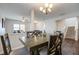Bright dining area with wooden table and chairs, chandelier, and vinyl floors at 491 Fox Sparrow Ct, Summerville, SC 29486