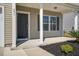 Inviting home exterior featuring a covered porch, neutral siding, and landscaped front yard at 491 Fox Sparrow Ct, Summerville, SC 29486