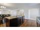 Open kitchen showcasing a center island with sink and seating, adjacent to the dining area at 491 Fox Sparrow Ct, Summerville, SC 29486