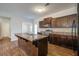 Well-equipped kitchen with dark cabinets, island, and modern appliances, perfect for cooking at 491 Fox Sparrow Ct, Summerville, SC 29486