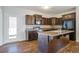Well-lit kitchen features dark cabinetry, stainless steel appliances, and an island with sink at 491 Fox Sparrow Ct, Summerville, SC 29486
