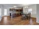 Open-concept kitchen with dark cabinets and granite countertops flowing into the dining area at 491 Fox Sparrow Ct, Summerville, SC 29486