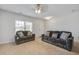 Spacious living room with neutral walls, carpet flooring, ceiling fan, and comfortable dark sofa seating at 491 Fox Sparrow Ct, Summerville, SC 29486