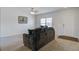 Cozy living room featuring neutral walls, carpet flooring, and comfortable dark-colored sofa seating at 491 Fox Sparrow Ct, Summerville, SC 29486