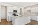 Bright and modern kitchen with white cabinets, stainless steel appliances, and a large center island at 509 Verdi Dr, Summerville, SC 29486
