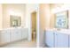 Bright bathroom with double sinks, white cabinetry, and tile flooring at 509 Yukon Ct, Lincolnville, SC 29485