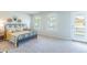 Bright bedroom features large windows, balcony access, and modern decor at 509 Yukon Ct, Lincolnville, SC 29485