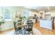 Bright dining area adjacent to kitchen, with wood floors and views to outdoors at 509 Yukon Ct, Lincolnville, SC 29485