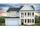 Charming two-story home with a covered porch and attached garage at 509 Yukon Ct, Lincolnville, SC 29485